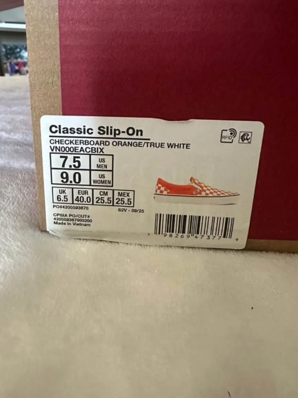 Orange and white checkerboard slip on vans